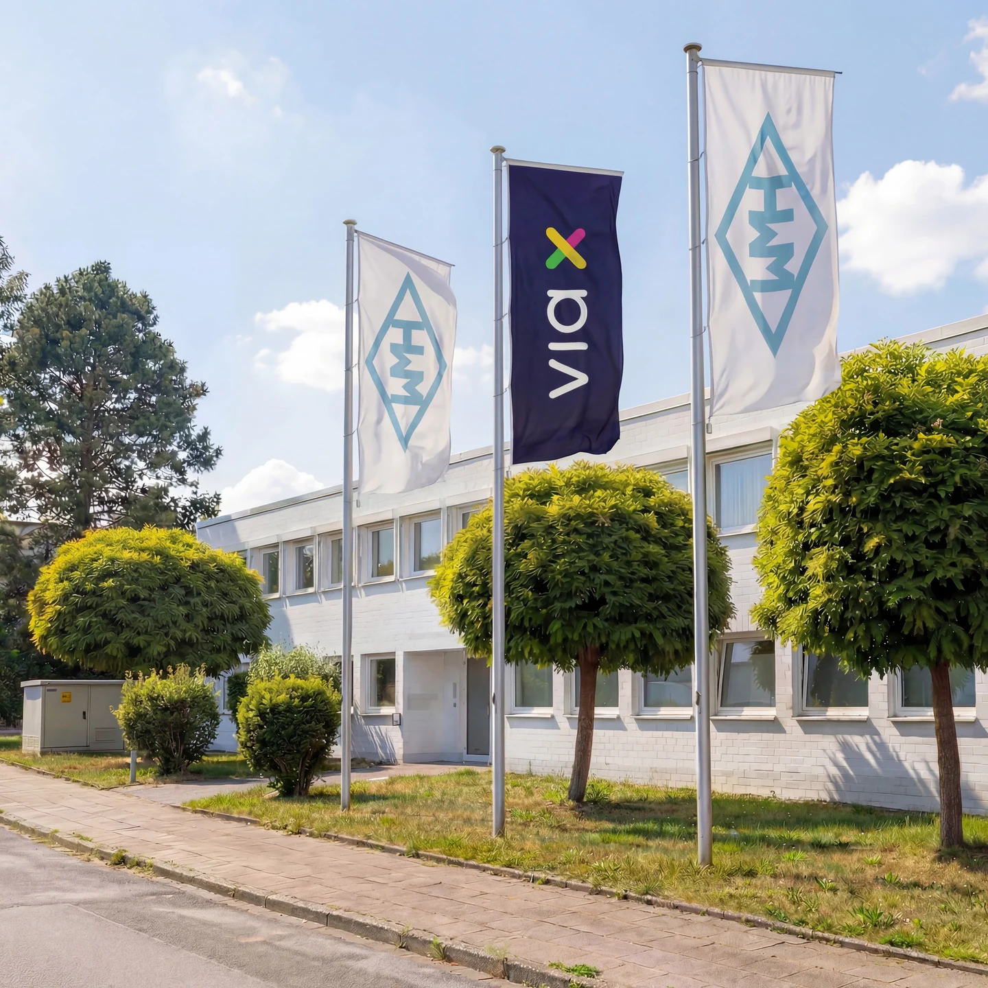 Our premises in Essen, with a VIA X flag in front of the office building